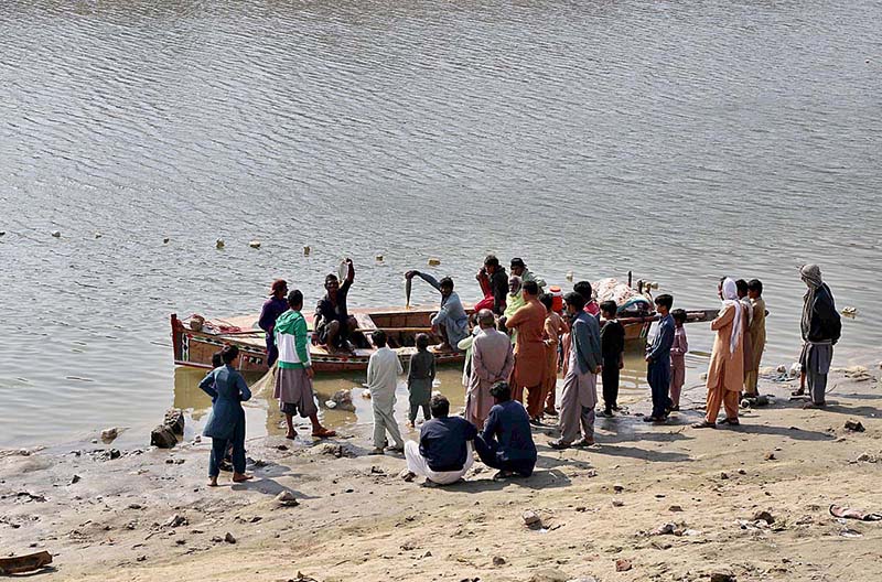 Fishermen showing fish after catching at Phuleli Canal