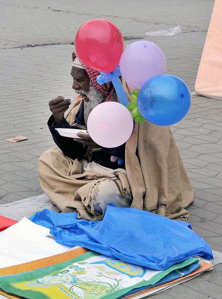 Street vendor selling cotton candy at Weekly Juma Bazar Peshawar Morr