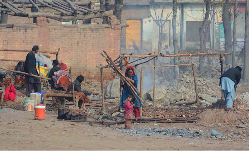 Gypsy family busy in making their temporary homes at their makeshift camp near Peer Zakori Bridge