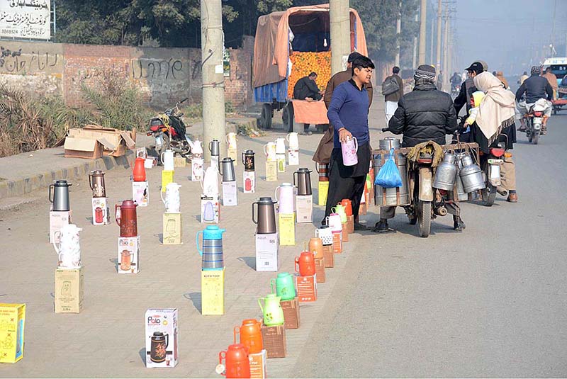 A vendor selling plastic thermos while displaying at roadside