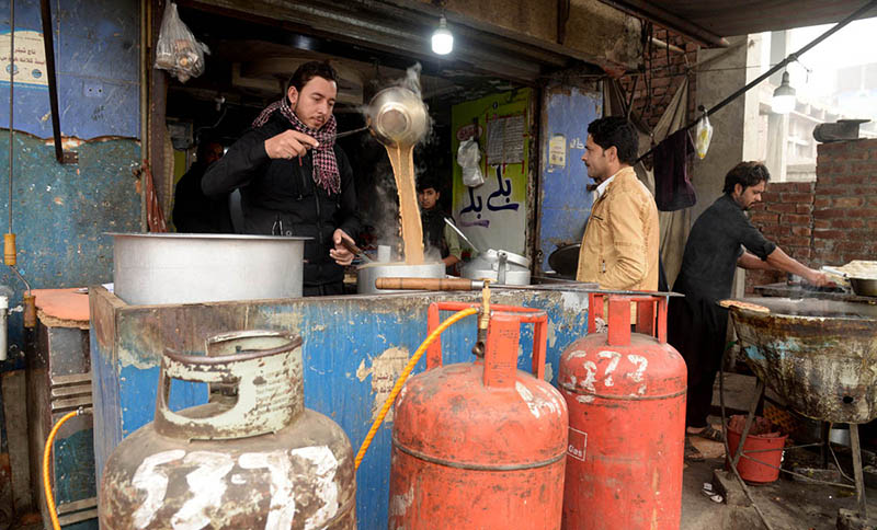 A vendor Making tea on a gas cylinder at his shop at Miklow Road