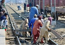 Railway workers repairing rail tracks at Railway Station