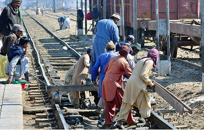 Railway workers repairing rail tracks at Railway Station