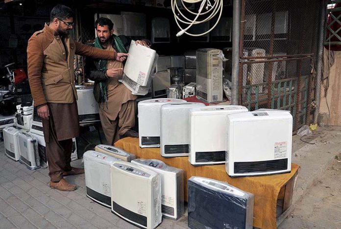 A man purchasing a gas heater at Weekly Juma Bazar Peshawar Morr