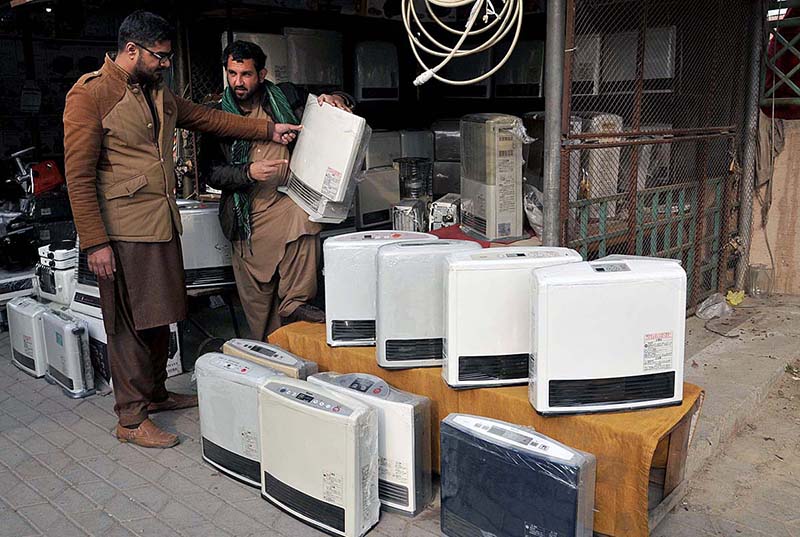 A man purchasing a gas heater at Weekly Juma Bazar Peshawar Morr