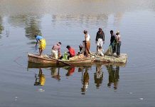 Fishermen busy in catching fish in their boats at Phuleli canal as the demand of fish increase during winter season across the country