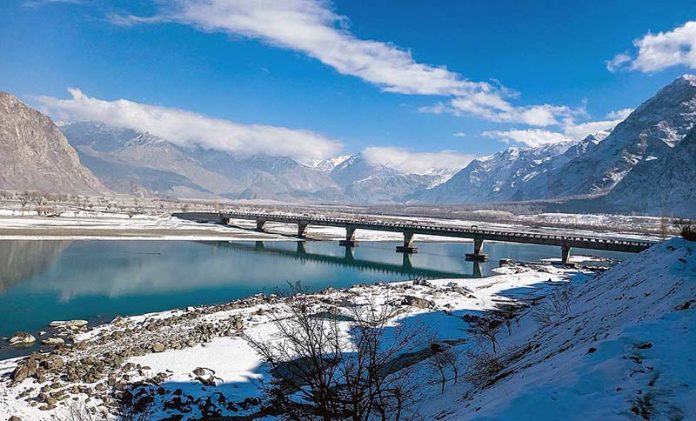 A view of Chumik RCC Bridge near Sarfaranga Cold Desert as in the background an attractive view snow covered mountains.