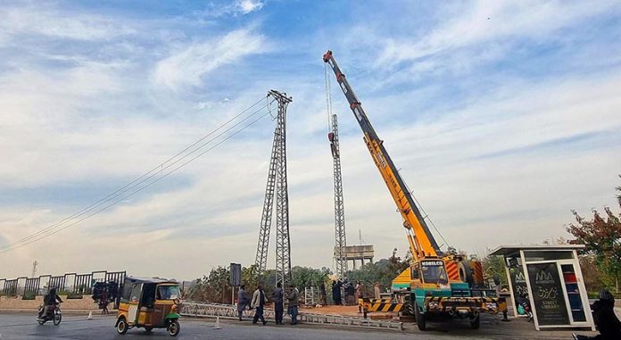 WAPDA workers are installing new electricity pylon at Moti Mahal neighbourhood