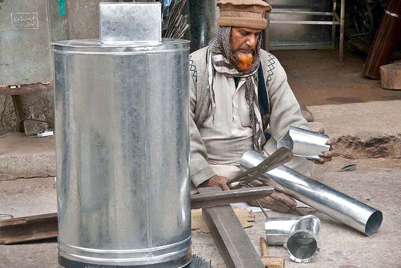 A worker is busy in making the stainless steel heating stove at their workplace in Provincial Capital
