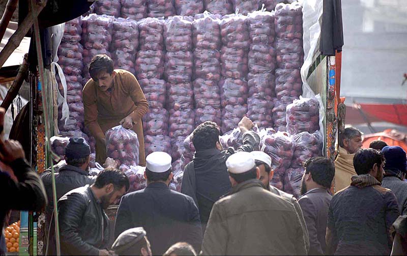 Fruit trader busy in trading apples from delivery truck at Fruit Market