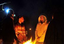 Youngsters gathered around fire to keep themselves warm in cold weather along road in G7 area as the mercury extremely dropped in the city
