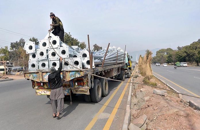 CDA workers unloading street light poles near Rawal Chowk