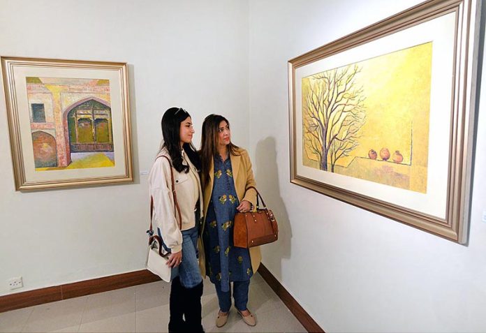 Visitors taking keen interest in painting during the exhibition by Artist Muhammad Javed at Pakistan National Council of the Arts