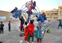 Children enjoying on portable swings at Sethi Town area
