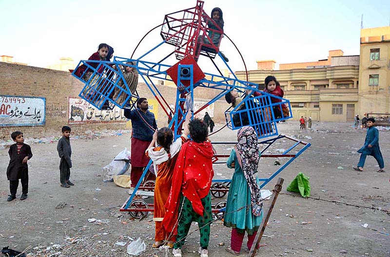 Children enjoying on portable swings at Sethi Town area