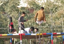 Children jumping on the trampoline at a roadside