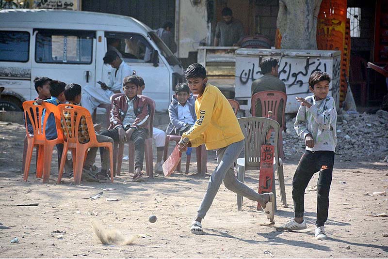 Young boys playing cricket during school holiday.