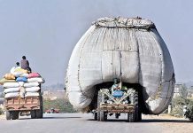 An overloaded tractor trolley with chaff (husk from wheat) on the way is violating the traffic rules and creating hurdles for smooth traffic flow at Bypass Road
