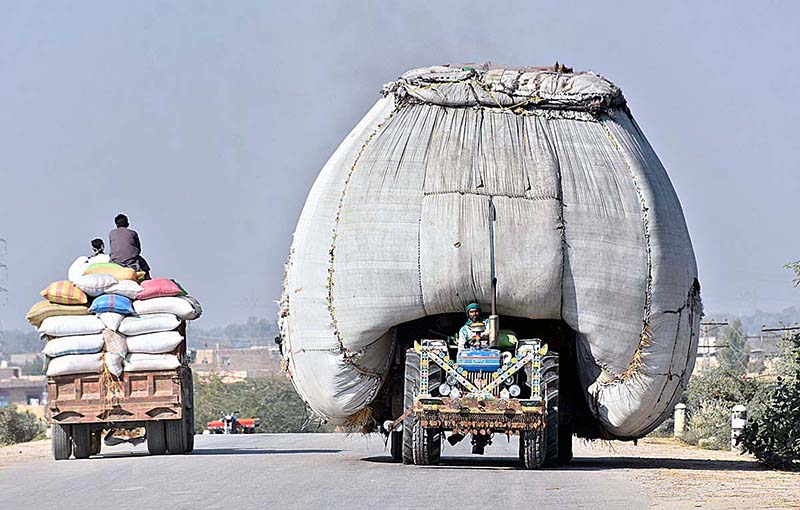 An overloaded tractor trolley with chaff (husk from wheat) on the way is violating the traffic rules and creating hurdles for smooth traffic flow at Bypass Road