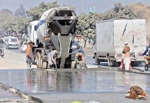 Heavy machinery being used in road construction on Islamabad Expressway.