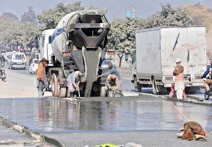 Heavy machinery being used in road construction on Islamabad Expressway.