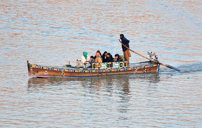 A family enjoying the boat ride in Indus River