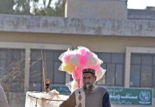 A vendor selling cotton candy and salty stuff on his bicycle at G-9 Markaz