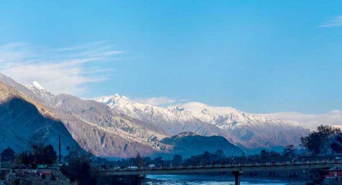An attractive view of sun set rays on snow caped mountain in the surrounding of the city.