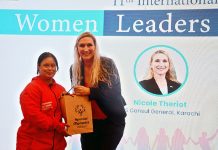 Special child presents a gift to US Consul General Nicole Theriot at the 11th International Women Leaders Summit