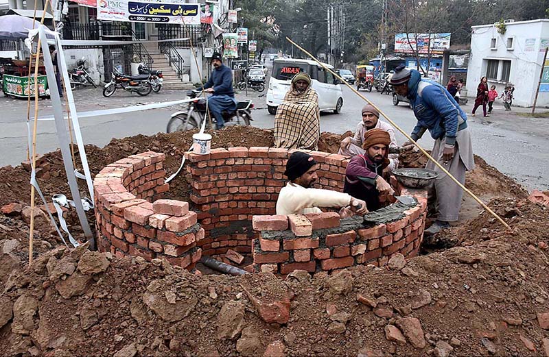 Masons are busy in construction to build sewage system during developing project in the city