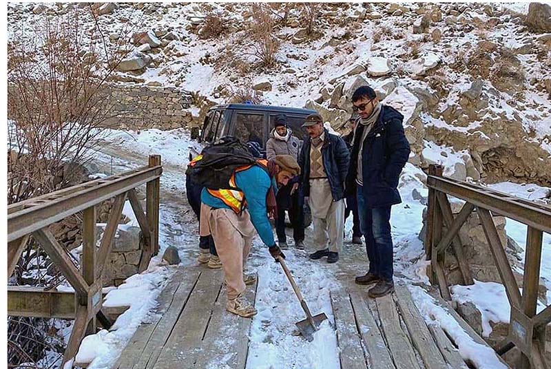 Highway personnel busy in removing snow from bridge and roads for smooth traffic flow during snow fall in north area in Pakistan.