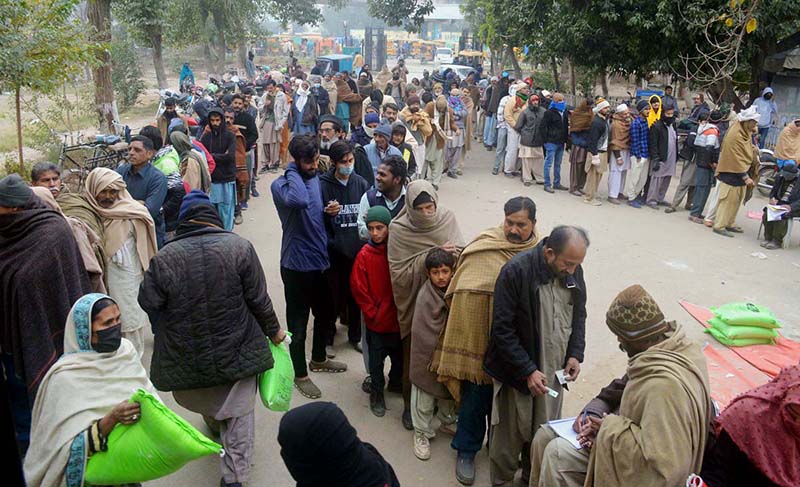 People are standing in a queue to purchase flour bags on subsidized rate