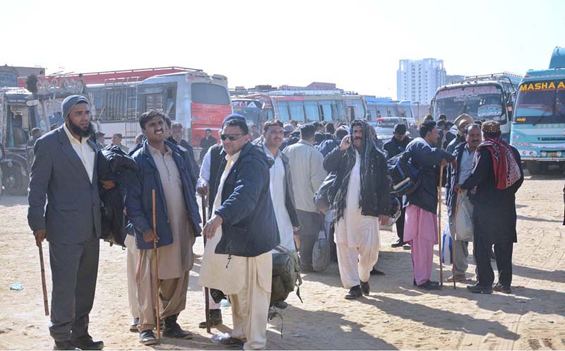 Policemen waiting for moving to their destination, who have come from interior Sindh to perform their duties in the Local Government elections, scheduled to be held on 15th January