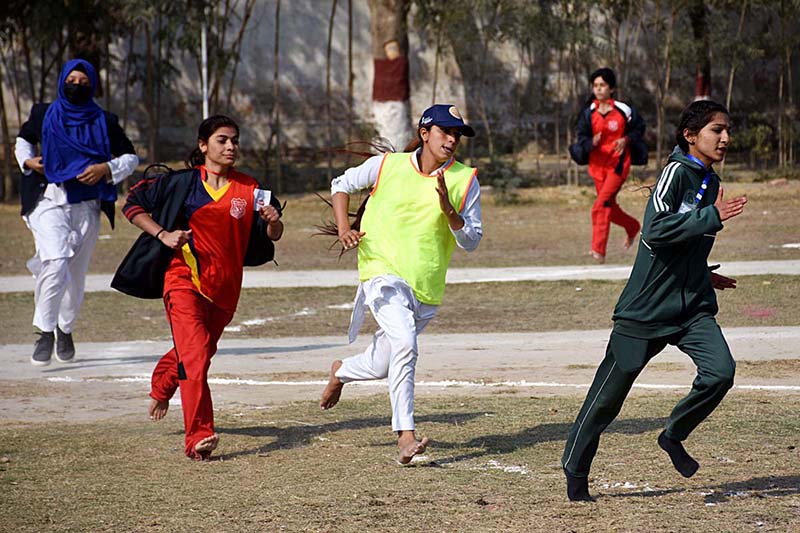 Director Colleges Professor Ahmed Bux Bhutto giving away trophy to winner athletes of Javelin Throw and 200 meters race to Govt. Girls Degree College Madeji team during prize distribution ceremony of 5th Sindh College Games 2023 at PTS Ground