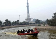 Visitors enjoy a boat ride in Greater Iqbal Park