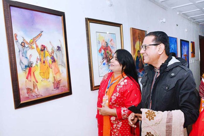 Visitors viewing paintings displayed during second day of the Sindh Sufi Melo at Sindh Museum