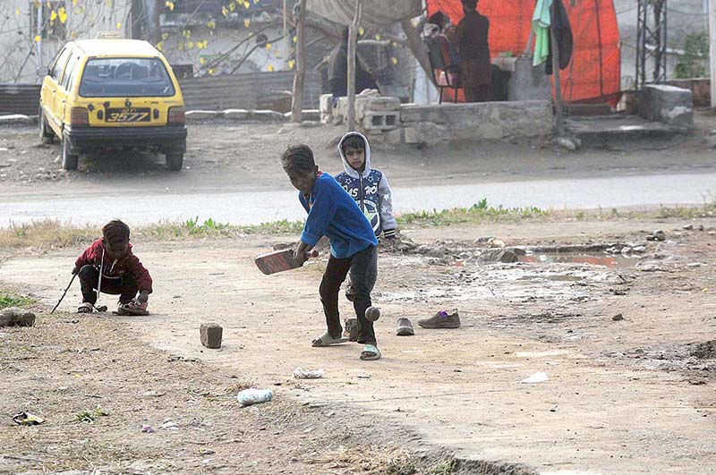 Children playing cricket on the road of G-7/1 sector in Federal Capital