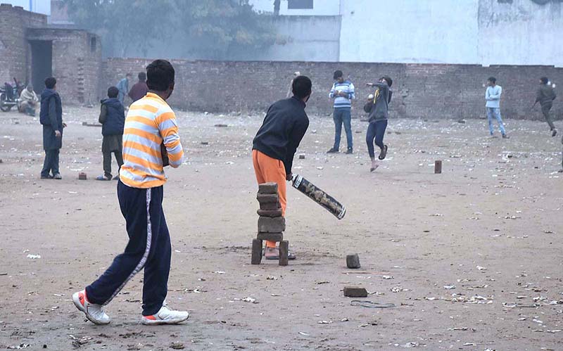 Youngsters are playing street cricket in local ground in the city