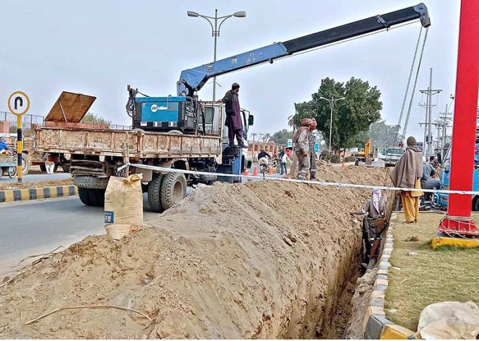 Workers of Sui Gas department are laying new gas pipe line underground on jhangi wala main road