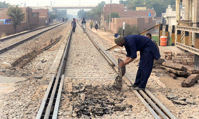 Railway worker busy in repairing work of Railway line near New Multan Railway station