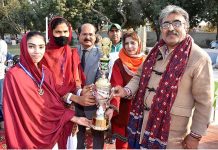 Director Colleges Professor Ahmed Bux Bhutto giving away trophy to winner athletes of Javelin Throw and 200 meters race to Govt. Girls Degree College Madeji team during prize distribution ceremony of 5th Sindh College Games 2023 at PTS Ground