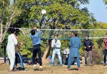 Youngsters playing volleyball at local park in G7 area