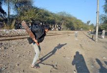 Children playing a cricket near railway track at old civil line