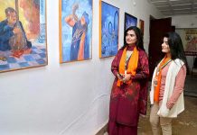 Visitors viewing paintings displayed at the Sindh Sufi Melo in Sindh Museum
