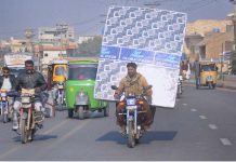 A motorcyclist on the way while carrying mattress foam on his motorcycle in a risky way