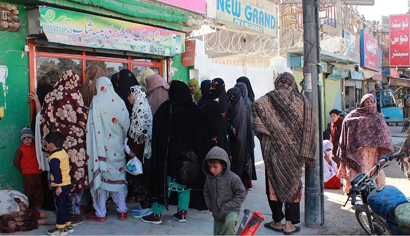 Women waiting in queue to receive cash of Benazir Income Support Program from Easypaisa Shop