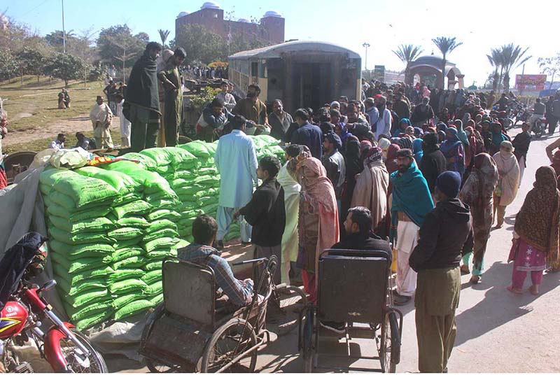 A large number of people standing in a queue to purchase flour bags on subsidized rates at Ghanta Ghar Chowk