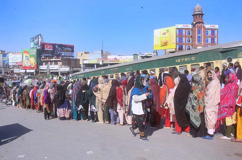 A large number of people standing in a queue to purchase flour bags on subsidized rates at Ghanta Ghar Chowk