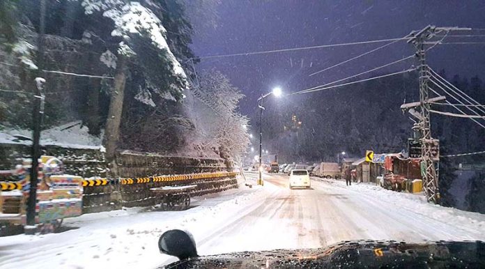 Commuters facing hurdle on snow paved road during heavy snowfall at the hilly town station
