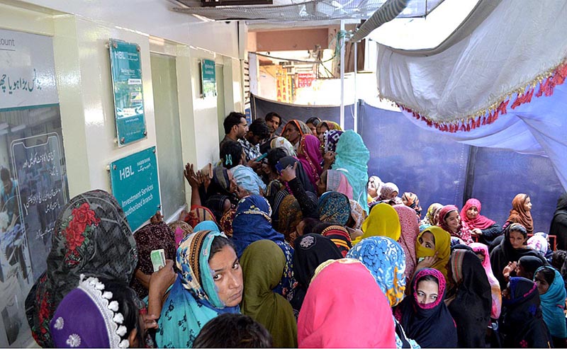 A large number of deserving women standing outside ATM machine of a bank to draw the Banazir income support Program cash at District Council Road